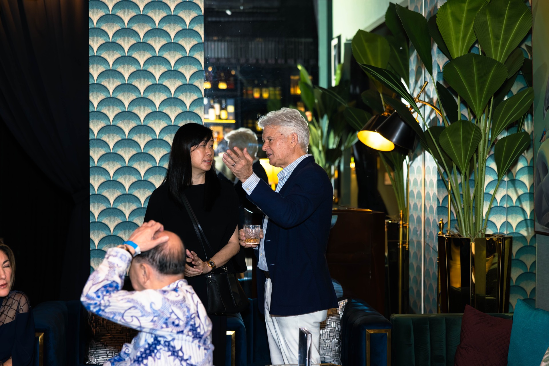 Guests sharing a conversation during a Pacific Club event